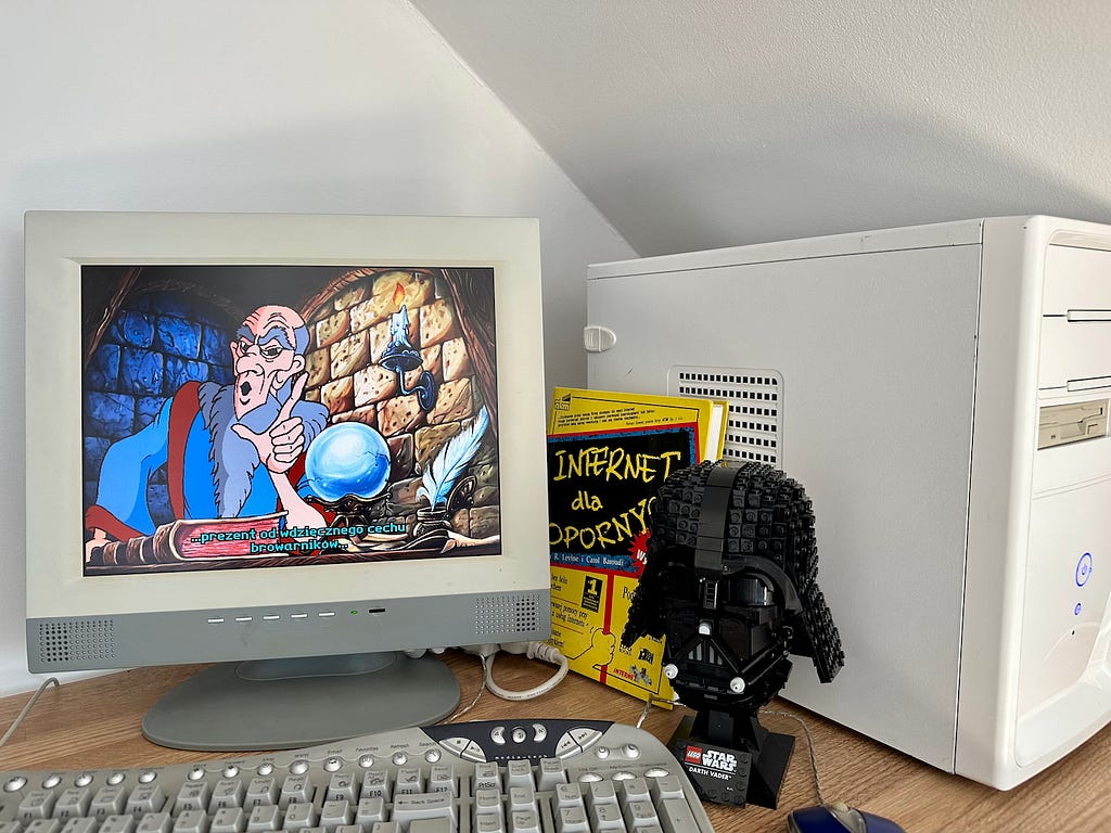 Windows PC with The Prince And The Coward game on screen, with Lego Head of Lord Vader and Internet For Dummies Book next to it.