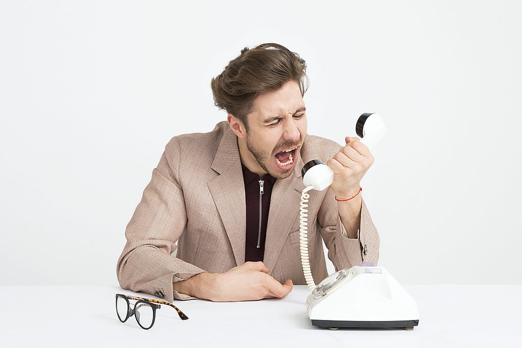 Image depicting an angry customer at the phone.