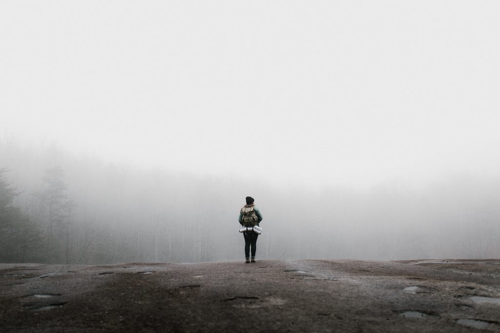 Girl alone wearing a backpack.