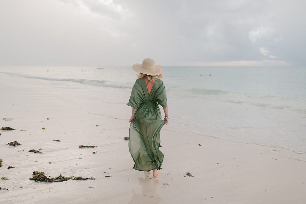 woman in a green sheer beach coverup