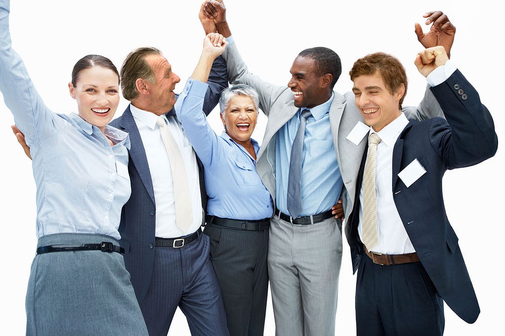 Image of people in business attire celebrating and smiling.