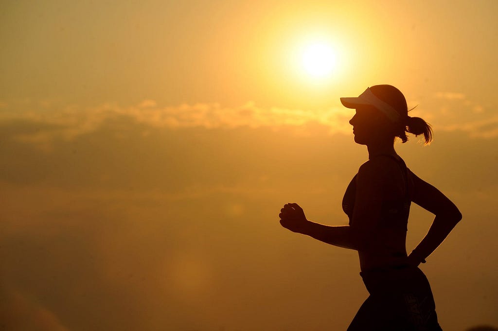 A girl running under sunshine to enhance her health