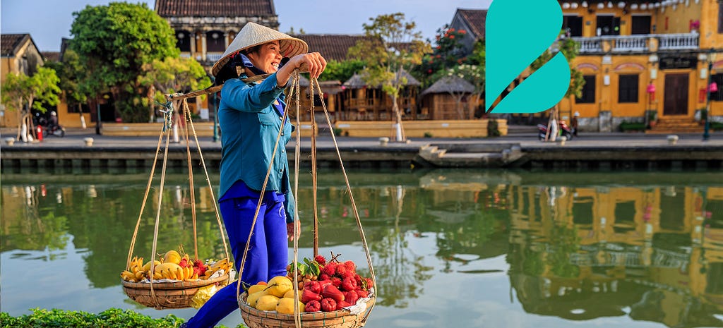Vietnamese woman carrying produce.
