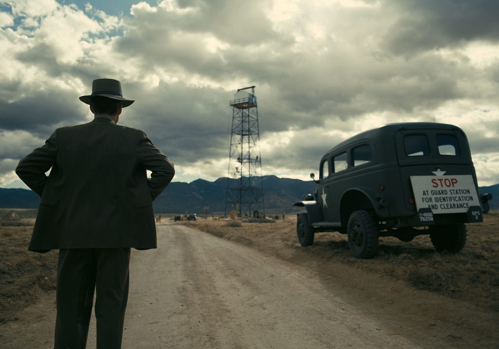 Robert J. Oppenheimer staring at the trinity tower in a wide and open desert called Los Alamos