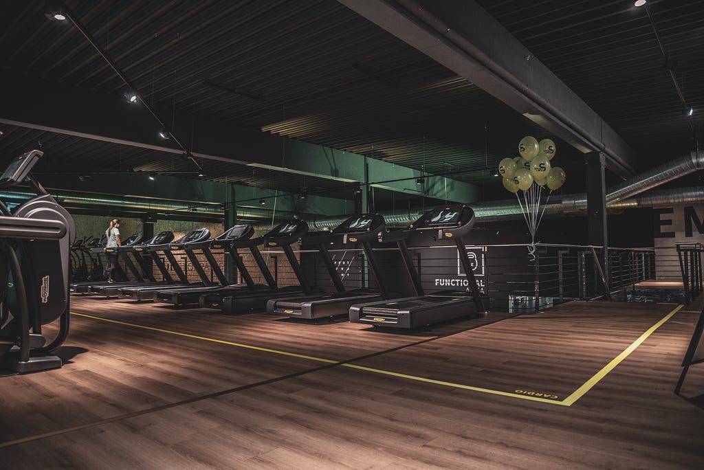A fancy, dimly-lit, bougie gym that doesn’t look anything like mine lol