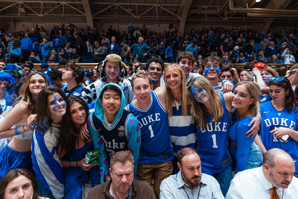 Group of Duke students in Duke apparel at a basketball game