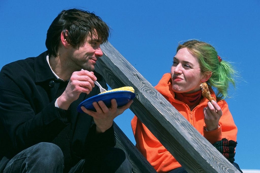 Clementine and Joel sile at each other as they eat.