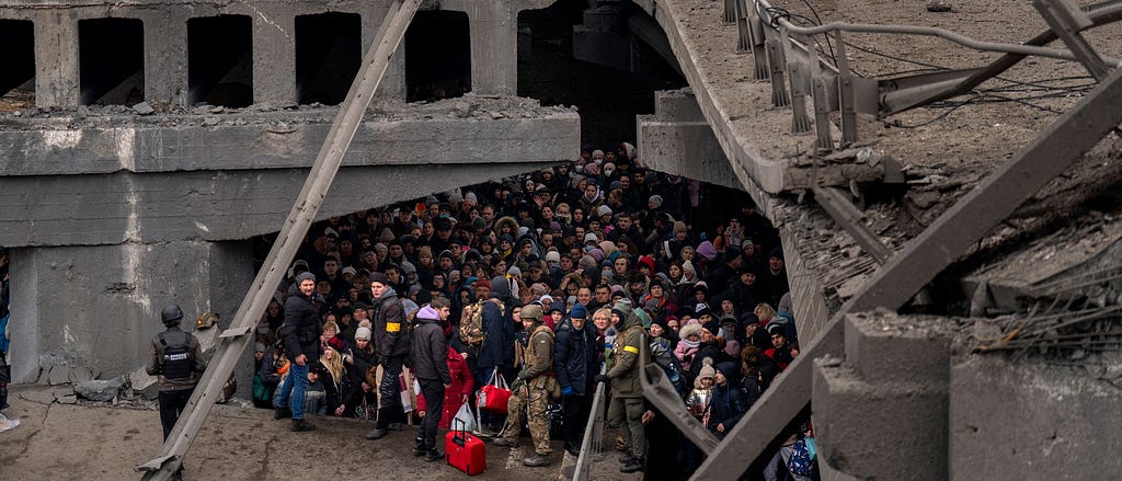 A large crowd of Ukrainians shelter underneath a damaged concrete bridge in Kyiv.