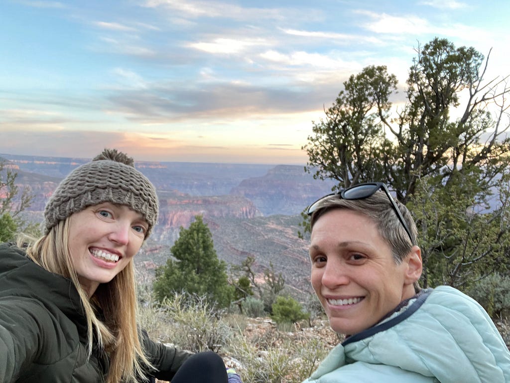 Selfie with two women looking out over the North Rim of the Grand Canyon at sunset.