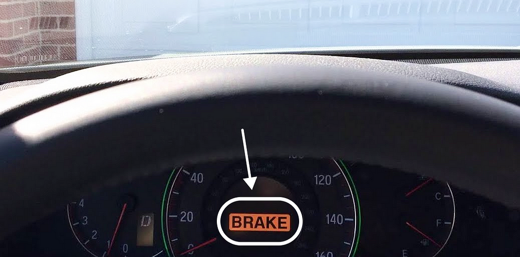 “BRAKE” showing up in orange warning on car dashboard when car about to hit closed garage door from front