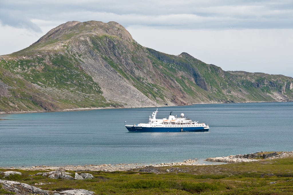 The Sea Adventurer waits while most of its passengers explore around St. John’s Bay in Labrador in eastern Canada.