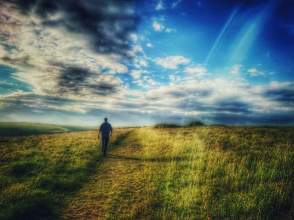 a man walking across the fields