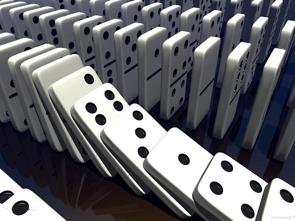 White domno blocks lined up to show the chain reaction of dominos collapsing.