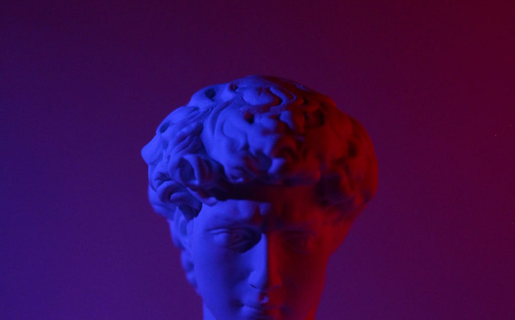 Roman head stone bust, cut off half way under moody purple-pink lighting