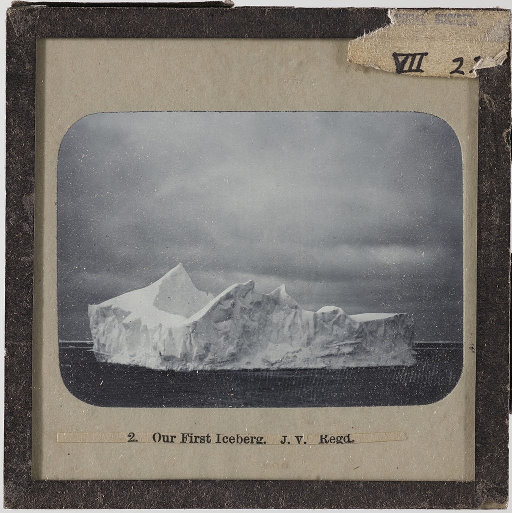 Photographic slide from the Manchester Geographical Society collection, showing an iceberg.