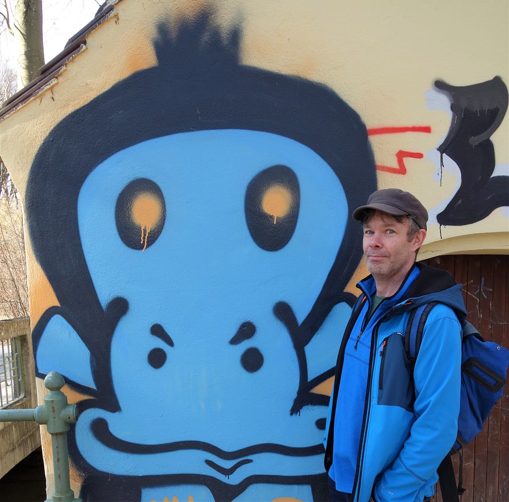 The author, in blue, looking seriously satisfied with himself standing beside his new best friend, a blue graffiti monkey.