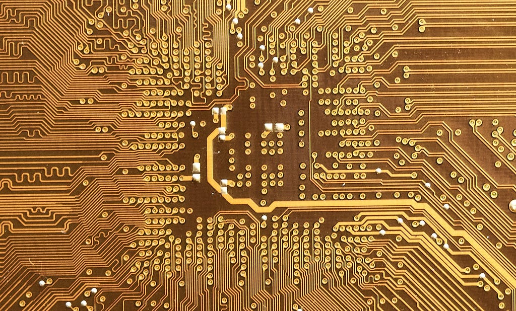 The back of a Printed Circuit Board (PCB) with a gold finish