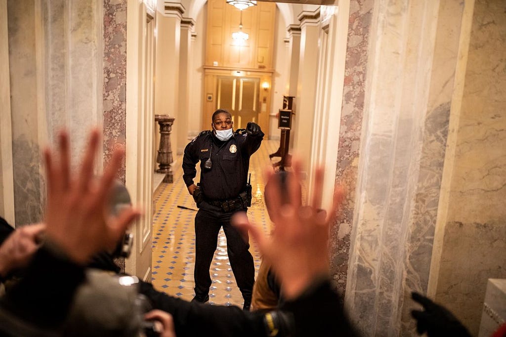 US Capitol Police Officer Eugene Goodman confronts protesters as they storm the building.