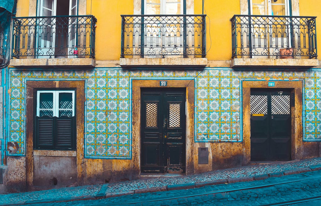 A buidling in Lisbon with colourful tiles on the façade.