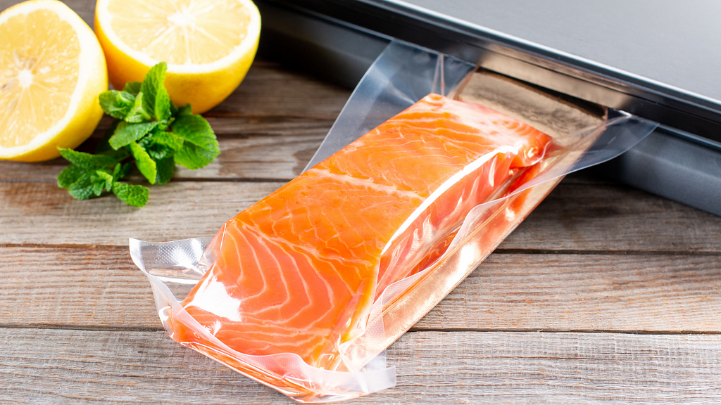 A salmon fillet shrink wrapped in plastic