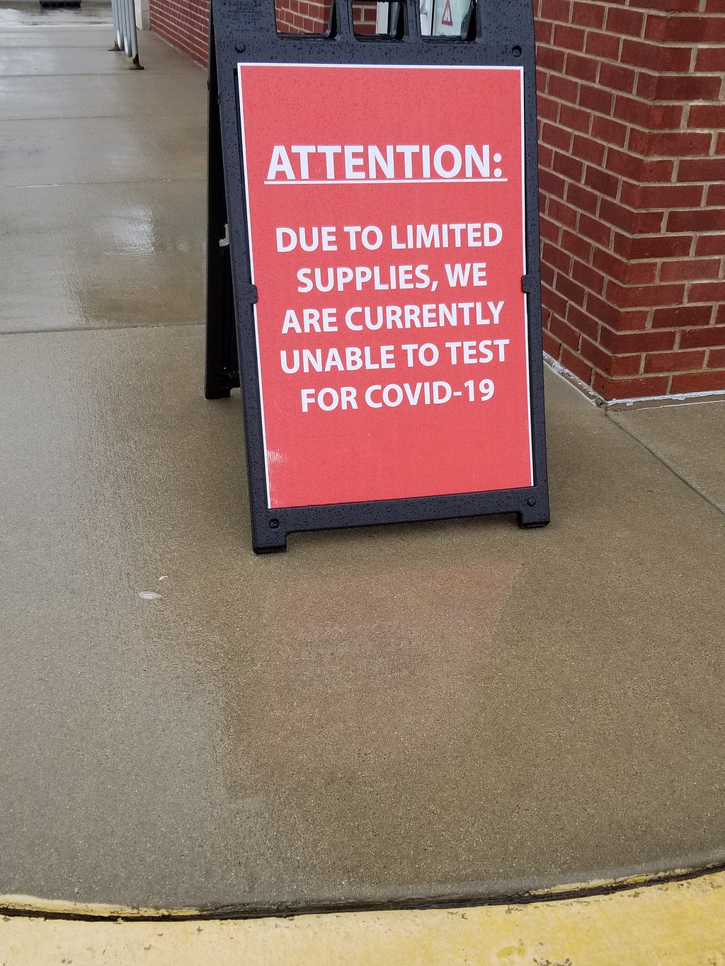 Signage outside of an urgent care facility currently low on testing supplies due to the overwhelming number of patients.