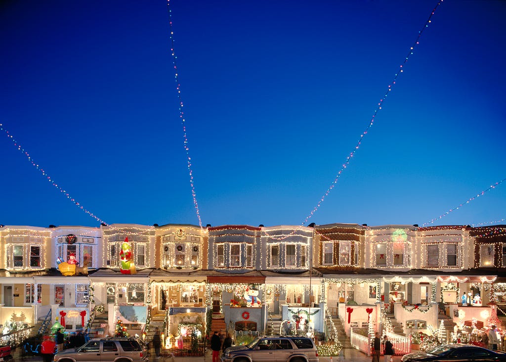 A row of houses with Christmas lighting