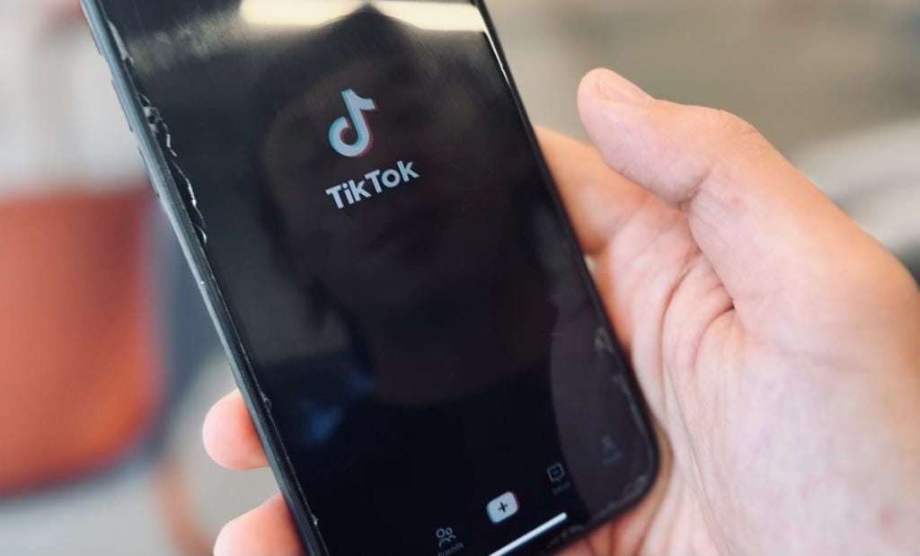 This picture of TikTok’s home page with its logo emphasizes how technology shapes our international online connections and acts as a potent emblem of the tremendous effects of digitalization on modern communication. An image taken on 12/10/2023.