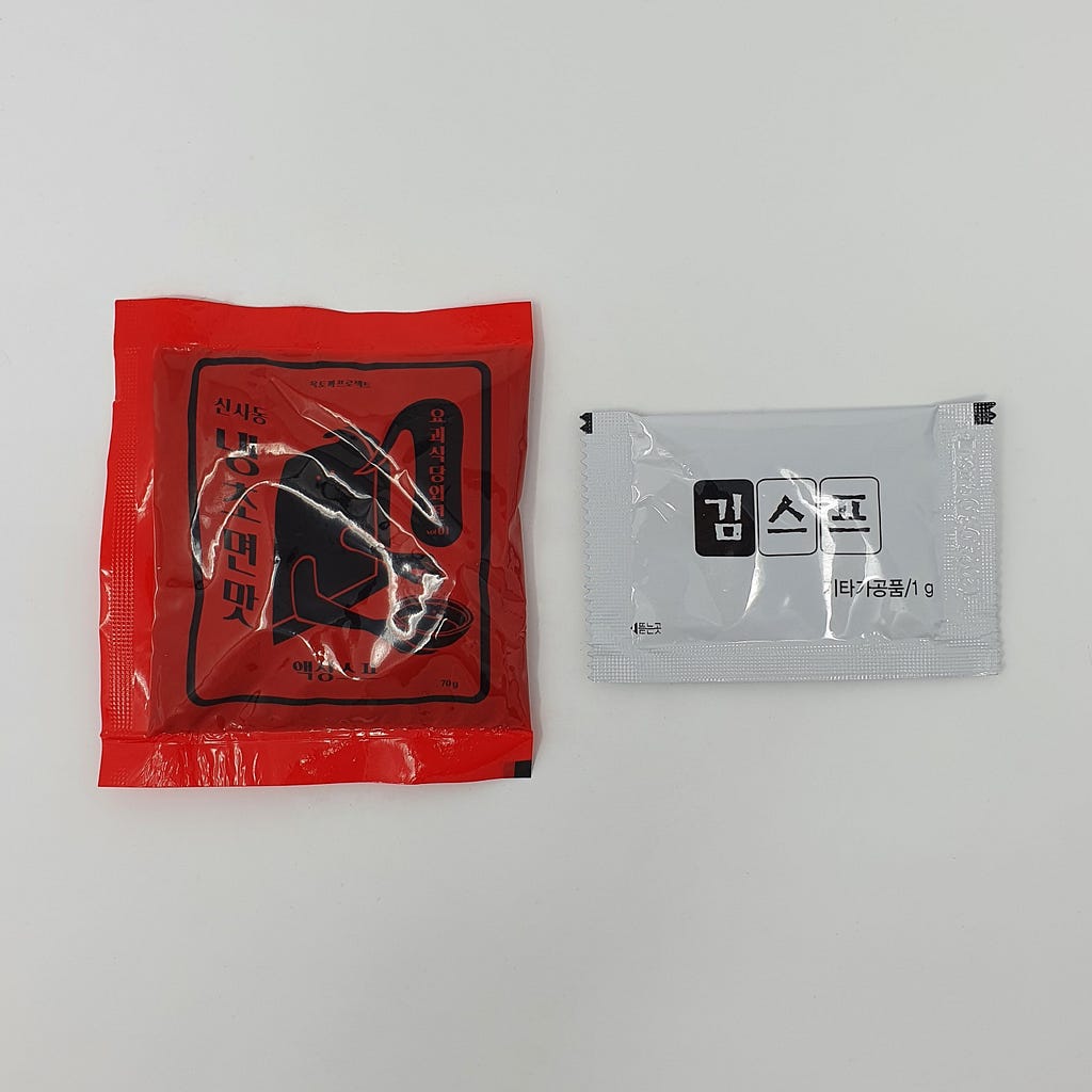 The two packets found in a package of Wicked Ramen (Yogoe Ramyeon) Shinsadong Naengcho-Myeon Flavor.