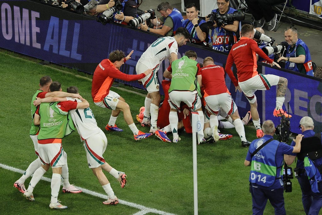 photo of Hungary players celebrating scoring a last minute goal