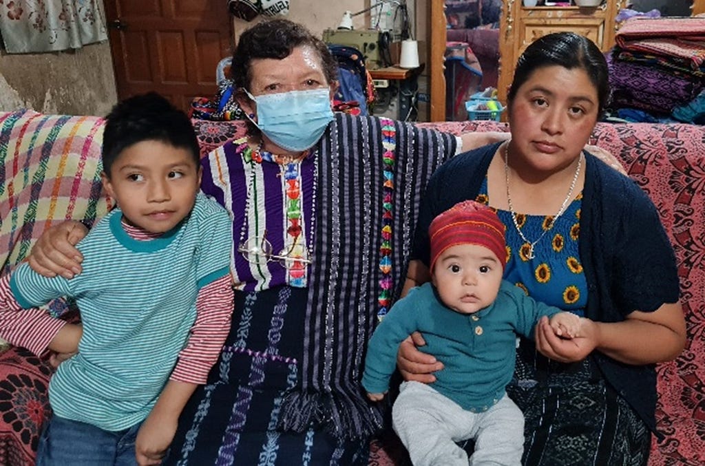 Romelia (left), a traditional midwife, played an important, lifesaving role for Francisca (right) by referring and accompanying her to the hospital during the birth of her second son, pictured her in h