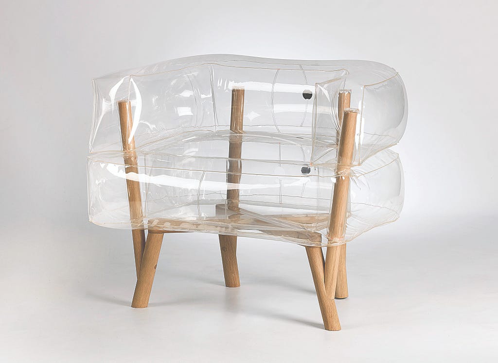 Chair with minimal wooden frame encased in transparent, inflatable cushions.