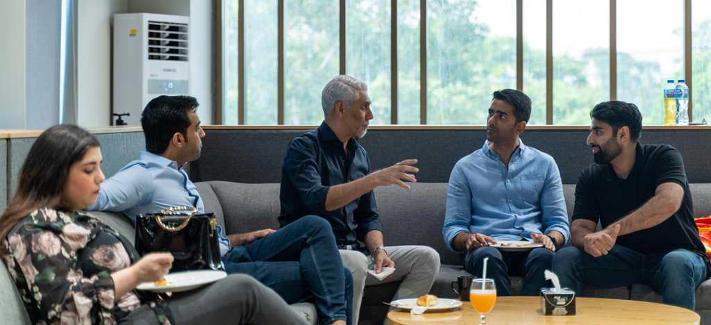 Vijay Tirathrai with Pakistani founders in a lounge at Daftarkhwan | Downtown