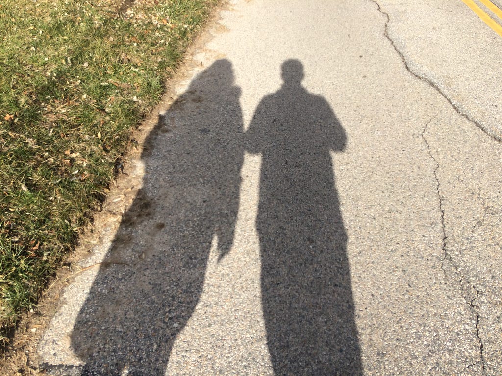Photo of the shadows of two people walking side by side