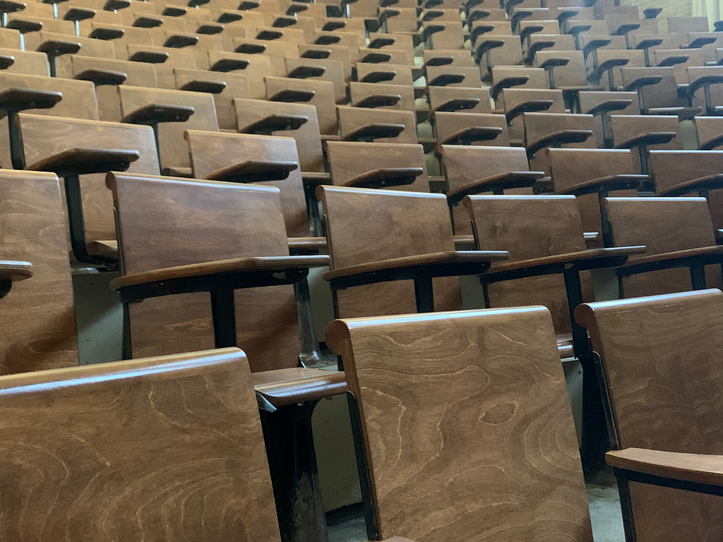 Rows of empty chairs in a lecture hall.