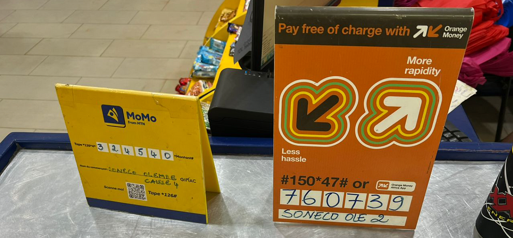 Signs in a shop with a unique SMS code to pay