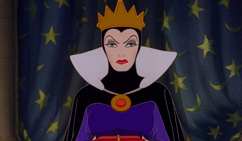 A close-up shot of the evil queen’s scowling face.