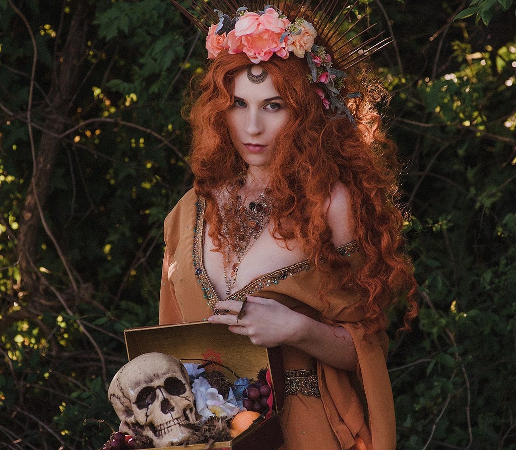 A young pagan woman holding a box with a skull