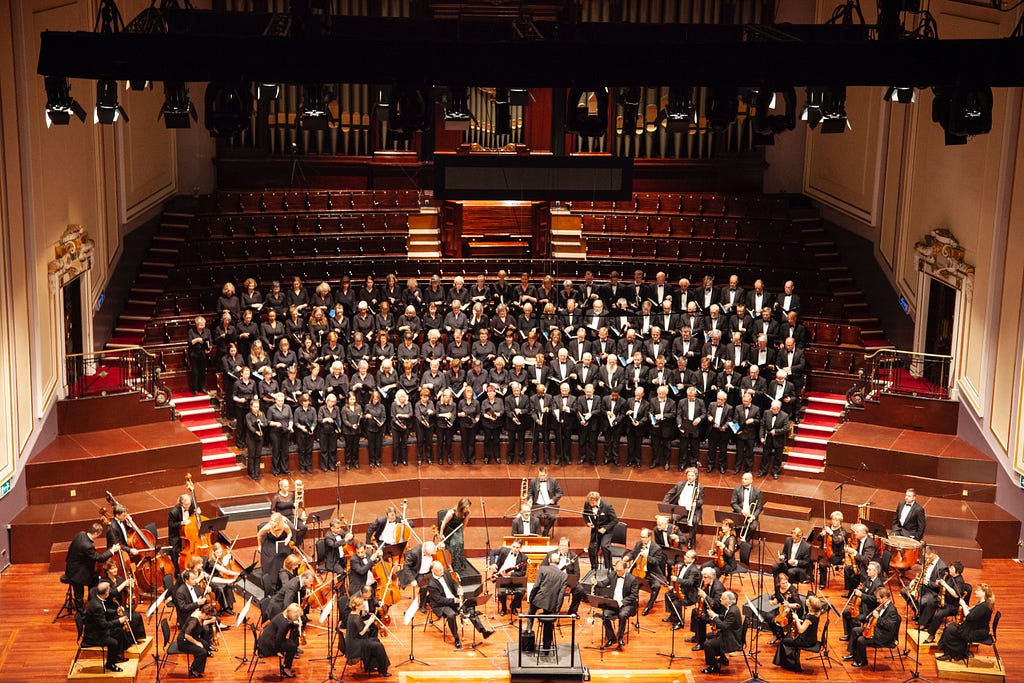An orchestra performing at a concert hall
