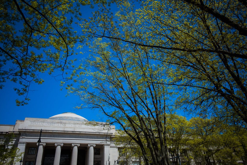 Photo of the MIT dome surrounded by trees in springtime