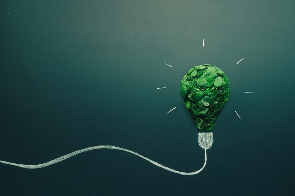 A lightbulb made out of green leaves representing climate technology or ClimateTech