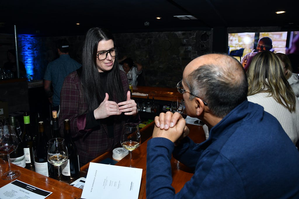 Lead Sommelier Elyse Lovenworth with a film producer at Sommsation Lounge. Photo by Stephen Lovekin.