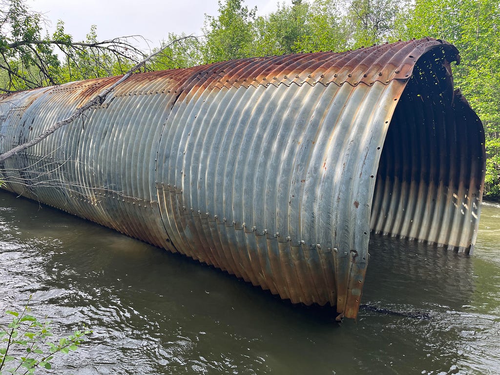 a round culvert sitting in a stream