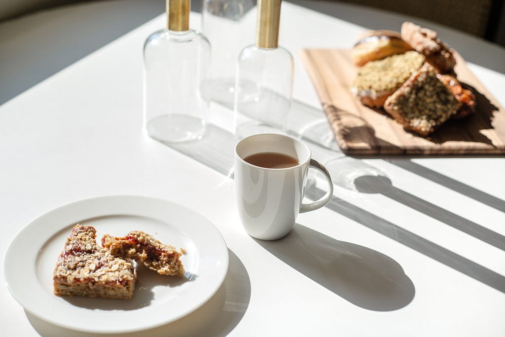 Breakfast treats and a mug of tea in the morning sun