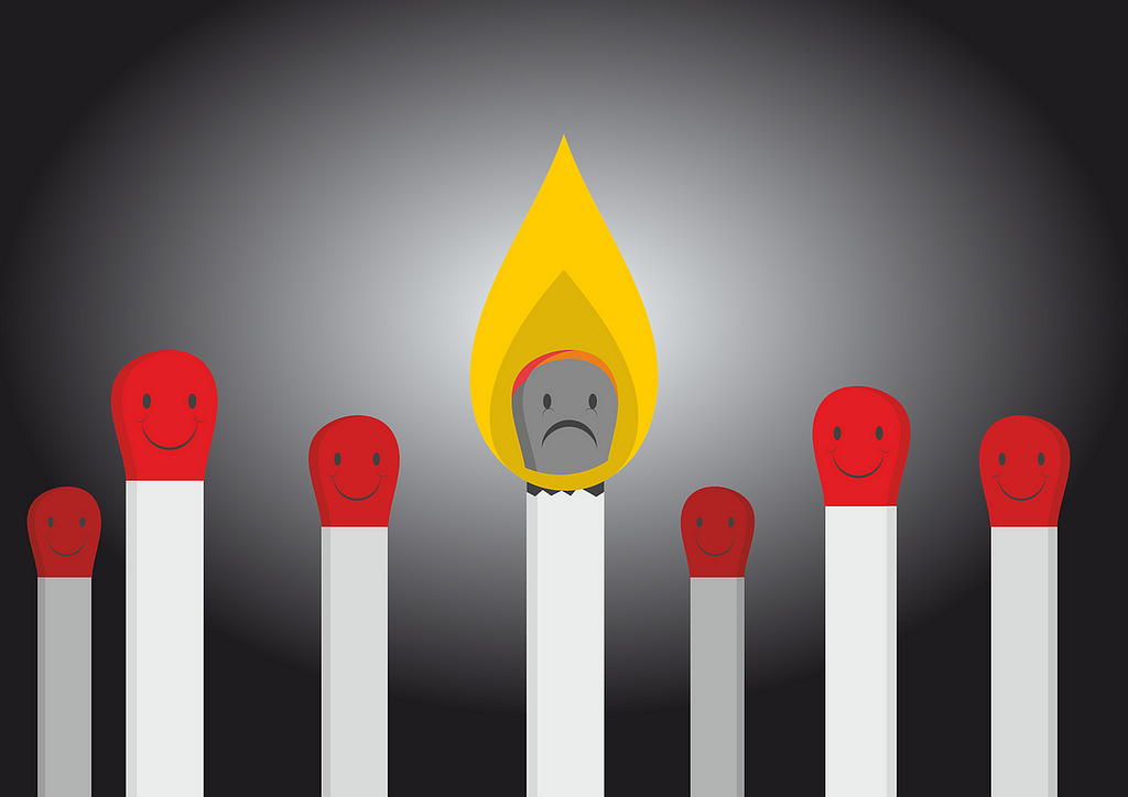 A cartoon of a lit match with a pained expression, surrounded by matches with happy expressions.