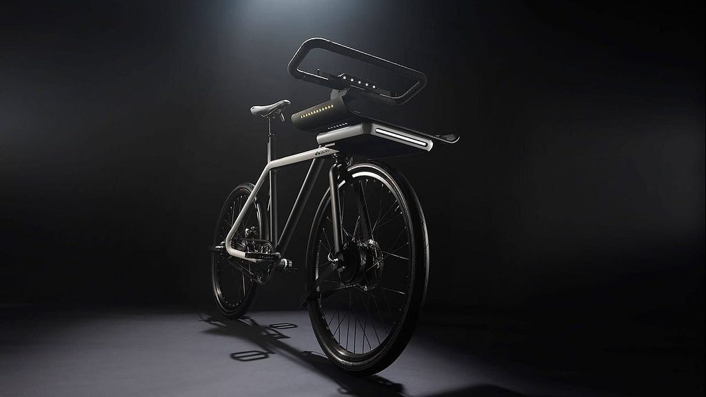 a bicycle coming out of darkness with futuristic lights and rectangular handlebars created by Seattle-based Teague.