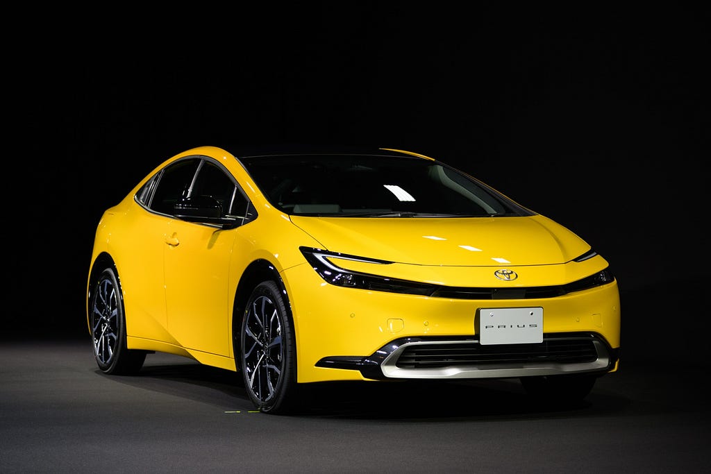 A yellow 2023 Toyota Prius hybrid.