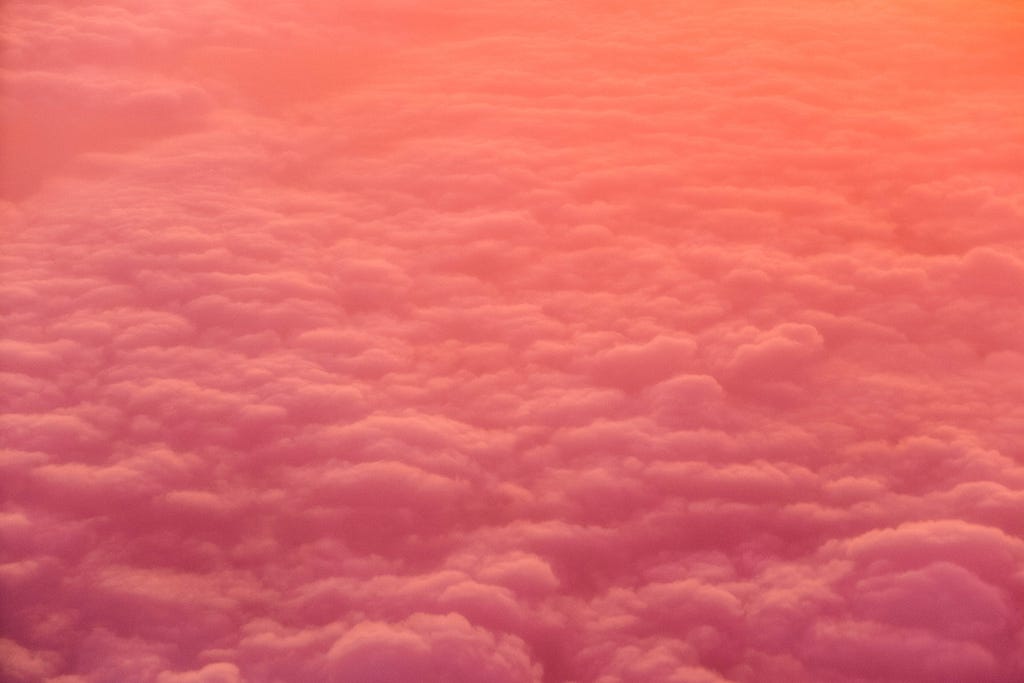 Pink and orange clouds seen from above