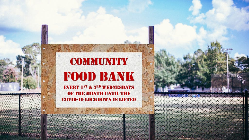 Wooden billboard outside a park, which reads “Community Food Bank every 1st and 3rd Wednesday of the month until the COVID-19 lockdown is lifted”.