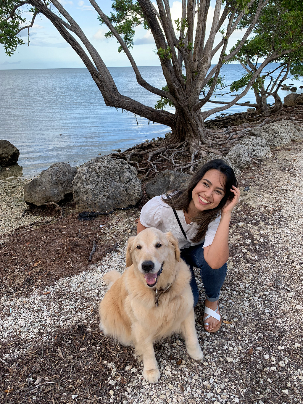 Angie and her golden retriever by the water.