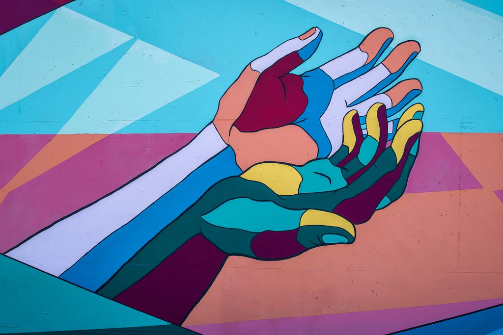A multicoloured painting of two hands outstretched & cupped together